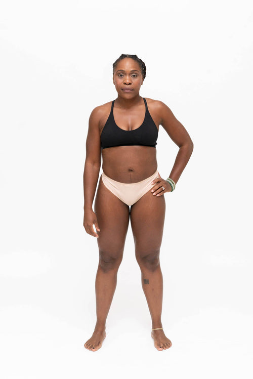 Dear Kate Nellie Thong leak-resistant period thong worn on model, front view on a white background.
