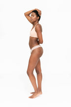 Dear Kate Ada Thong lace leak-resistant period thong worn on model, front view on a white background.