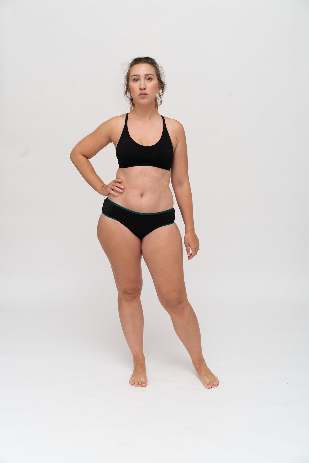 Dear Kate Hazel Hipster Mini in Emerald Green, worn on model on a white background.