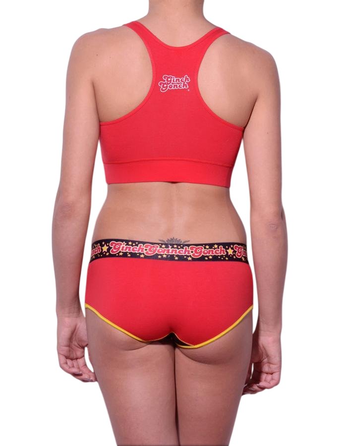 Full length rear view of a model wearing Ginch Gonch red atomic fireballs boyfriend cotton stretch brief with a sports bra.