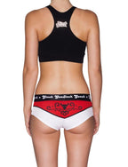 Rear view of a model wearing Ginch Gonch El Toro Gogo Briefs with a matching black sports bra, featuring a bull-rider print and cotton stretch details.
