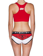 Full length rear view of a model wearing Ginch Gonch El Toro Women's Boyfriend Briefs in bull-rider print with red sports bra.