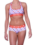 Ginch Gonch gogo brief white color with sporty print stretchable cotton underwear worn with a matching sports bra by a model with a white background.