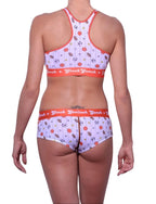 Full length rear view of a model wearing Ginch Gonch gogo brief white color with sporty print stretchable cotton underwear with a matching sports bra and a white background.