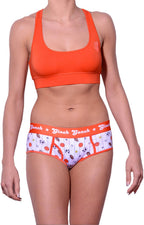 Ginch Gonch orange color boyfriend brief stretchable cotton underwear panty worn with an orange sports bra by a model with a white background.