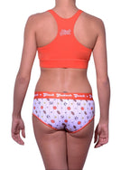 Full length rear view of a model wearing Ginch Gonch sporty print hardball boyfriend cotton stretch brief with an orange sports bra.