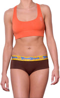 Ginch Gonch gogo brief brown color stretchable cotton worn with an orange sports bra by a model with a white background.