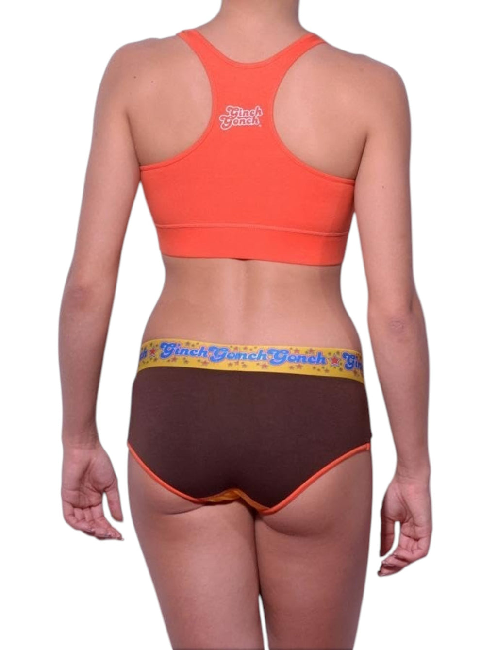 Full length rear view of a model wearing Ginch Gonch yellow and brown lemon head cotton stretch boyfriend brief with an orange sports bra.