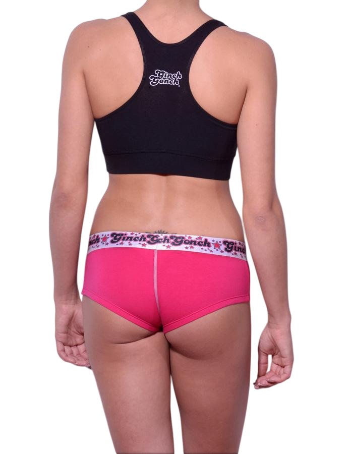 Full length rear view of a model wearing Ginch Gonch pink and white gogo cotton stretch brief with a black sports bra.