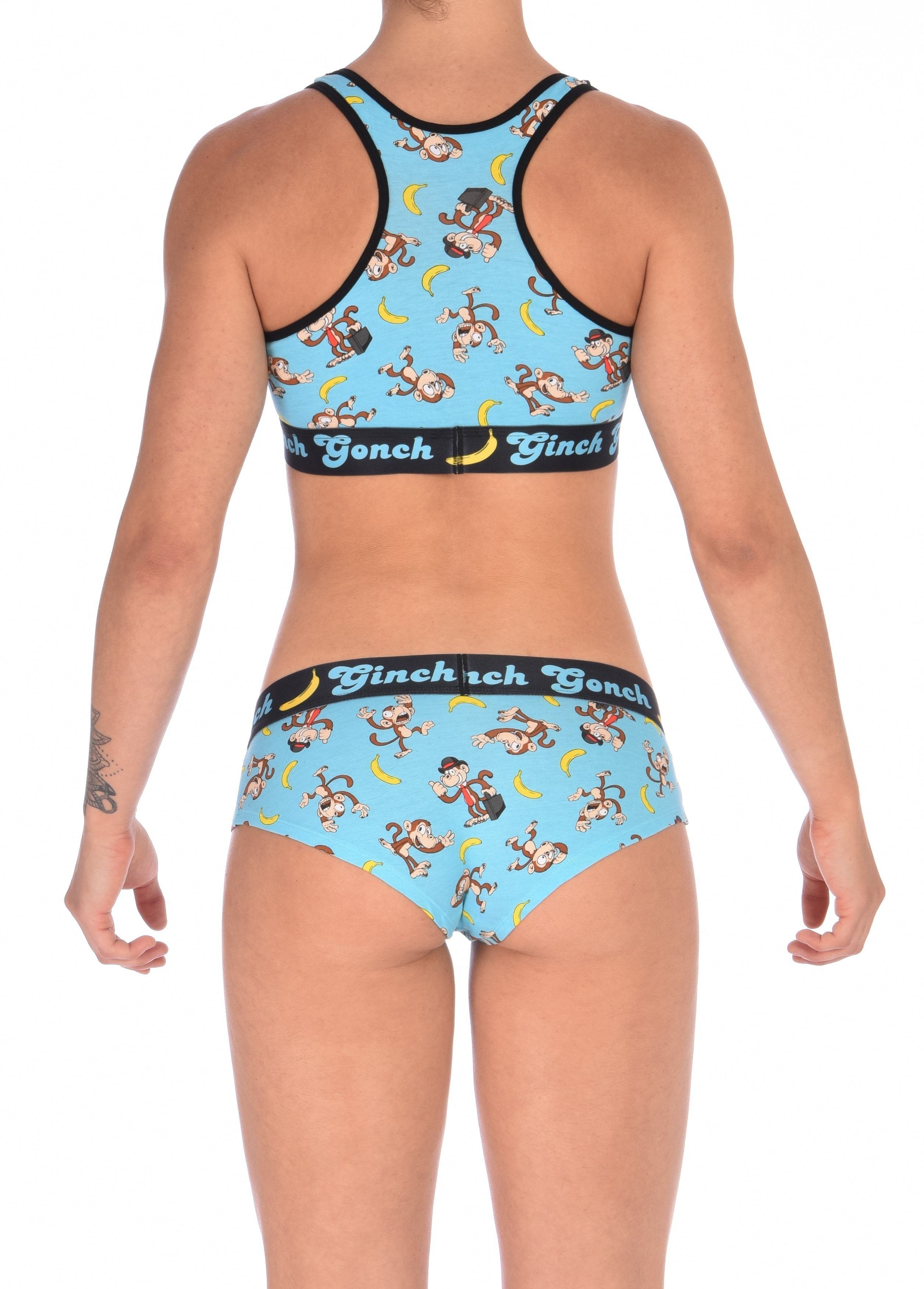 From behind view of a model Ginch Gonch Monkey Business Women's Gogo Briefs in aqua monkey banana print, gogo cut, anti muffin-top waistband, model with matching sports bra.