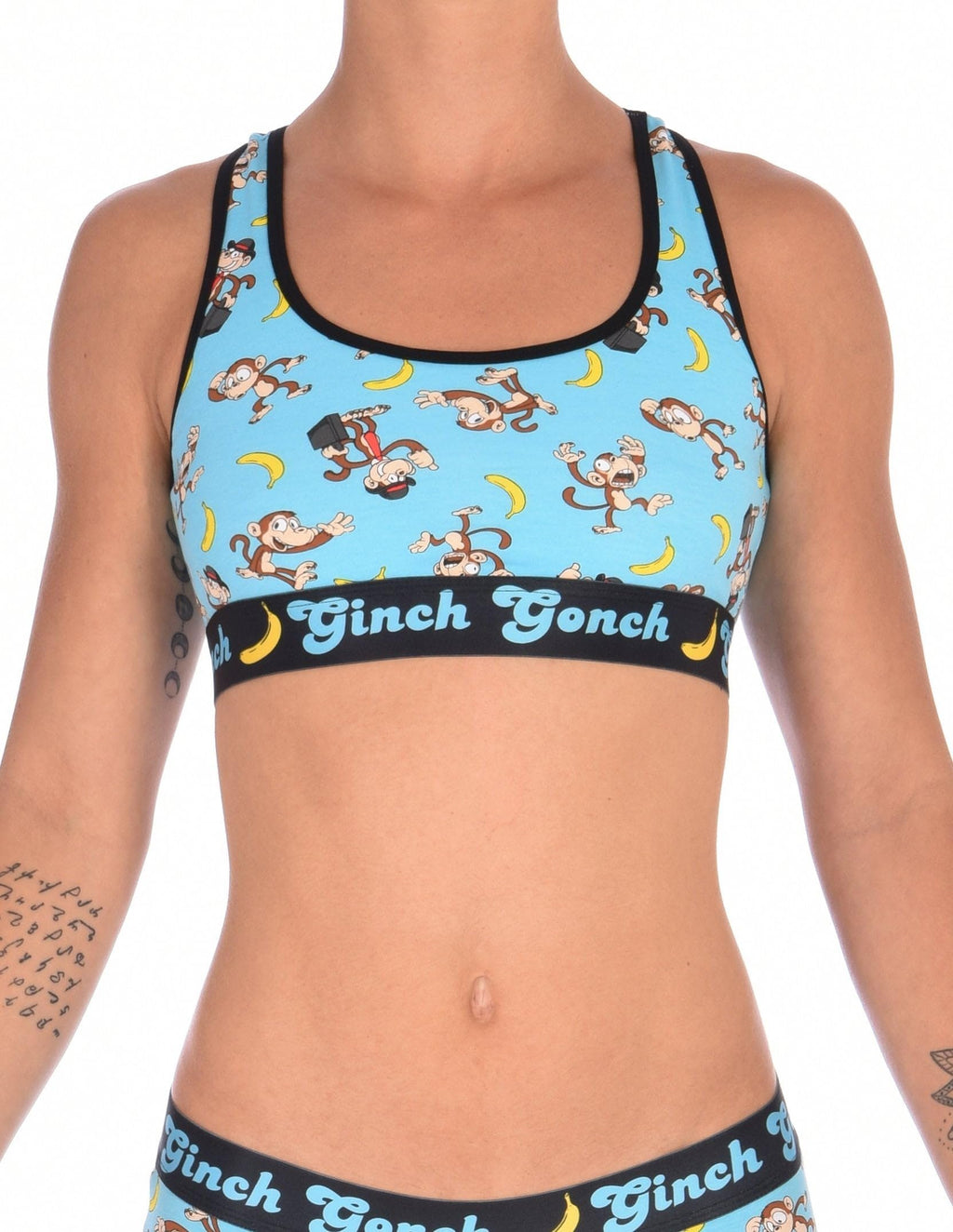 Ginch Gonch Monkey Business Women's Sports Bra, aqua blue with black underband, all-over monkey banana print, 4-way stretch cotton, waist-up on model.