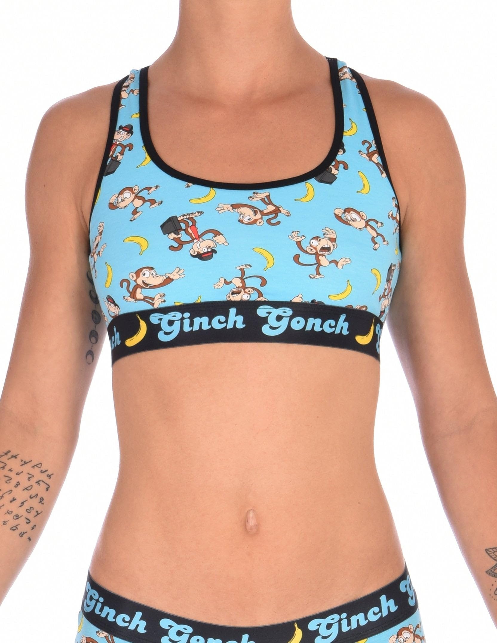 Ginch Gonch Monkey Business Women's Sports Bra, aqua blue with black underband, all-over monkey banana print, 4-way stretch cotton, waist-up on model.