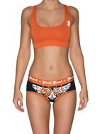 Ginch Gonch Rock Me Boyfriend Briefs black with orange waistband and skull guitar print with an orange sports bra worn by model.