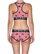 Viewed from behind of a model wearning Ginch Gonch Wild Bulls Women's Boyfriend Briefs, red white bull stripe print, relaxed boyfriend cut matching sports bra.