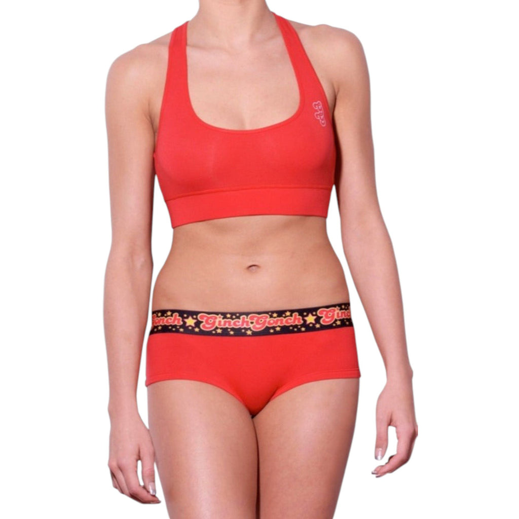 Ginch Gonch gogo brief red color stretchable cotton worn with a sports bra by a model with a white background.