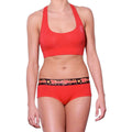 Ginch Gonch gogo brief red color stretchable cotton worn with a sports bra by a model with a white background.