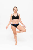 Dear Kate Hazel Hipster Full in Black, worn on model in yoga pose on a white background.