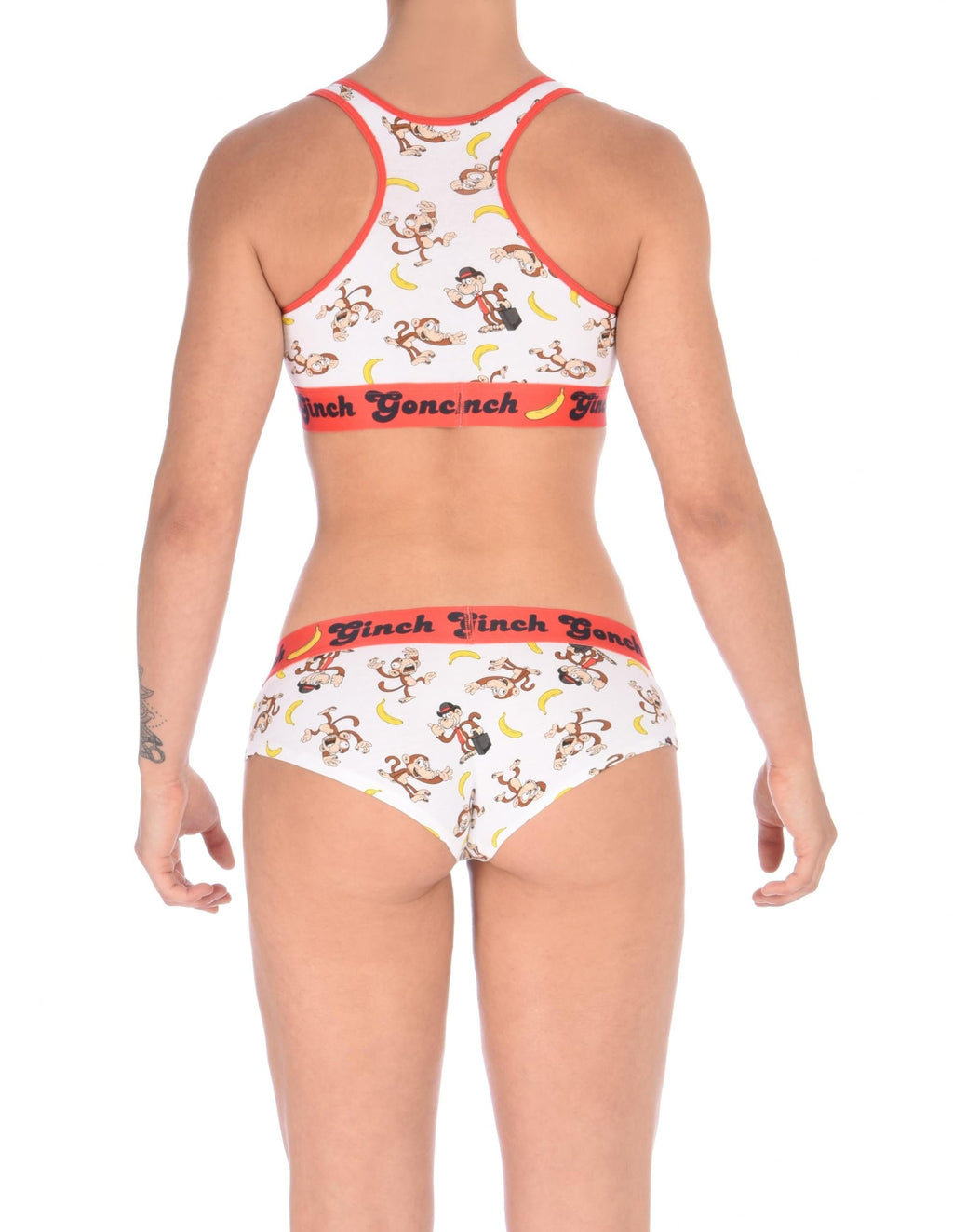 Viewed from behind, rear view of Ginch Gonch Gone Bananas gogo briefs showing anti-muffin waistband and monkey print stretch cotton with matching sports bra.