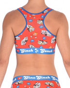 Rear view of a model wearing a orange  Ginch Gonch GG EMT sports bra showing racerback design and medical print stretch cotton.