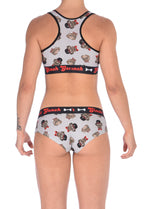 Seen from behind of a model wearing of Ginch Gonch Pug Life grey gogo briefs showing anti-muffin waistband and pug print stretch cotton paired with a similar sports bra.