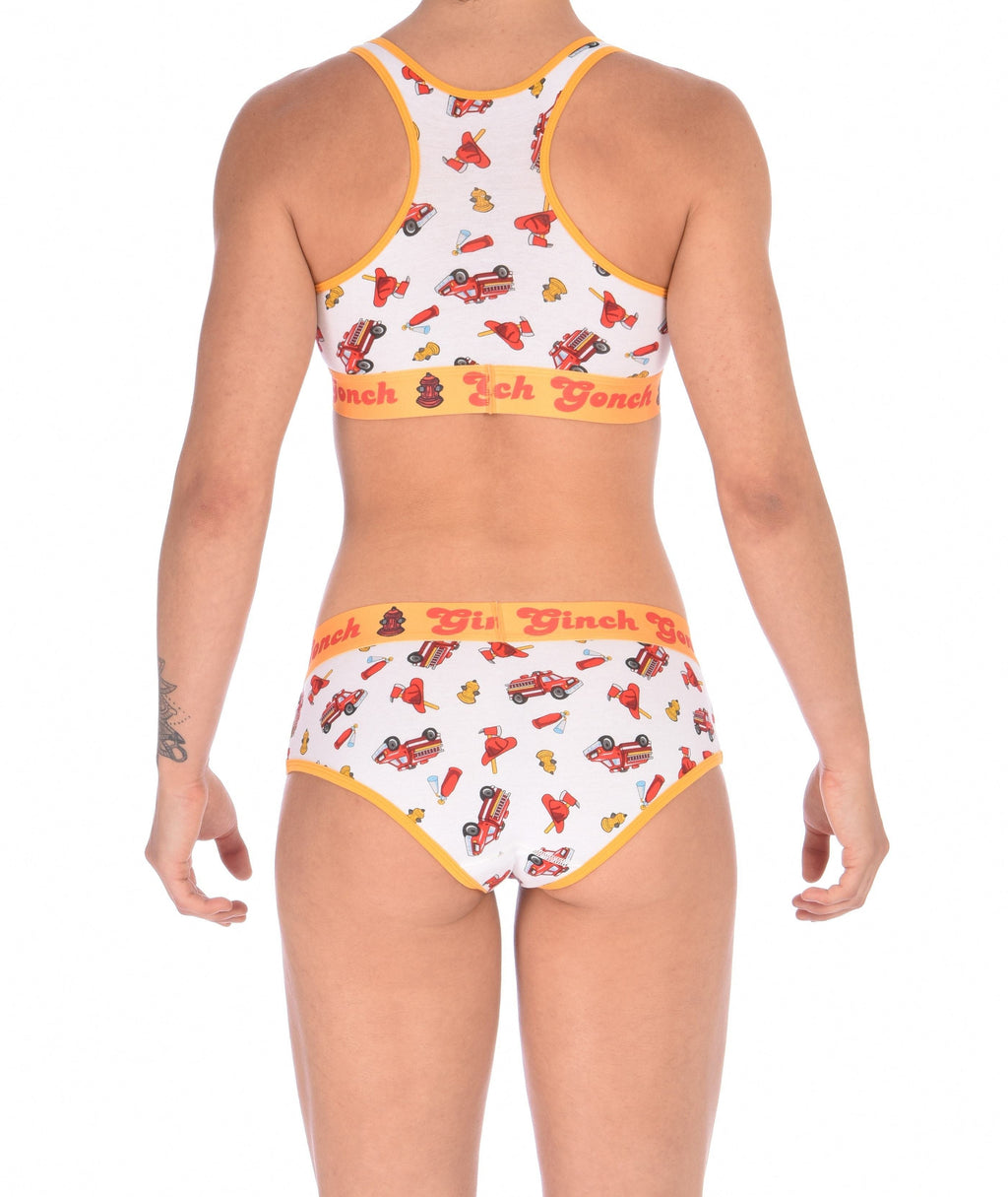 From the back of a model wearing a Ginch Gonch GG Fire Fighters boyfriend briefs showing full seat coverage and firefighter print cotton and same printed sports bra.