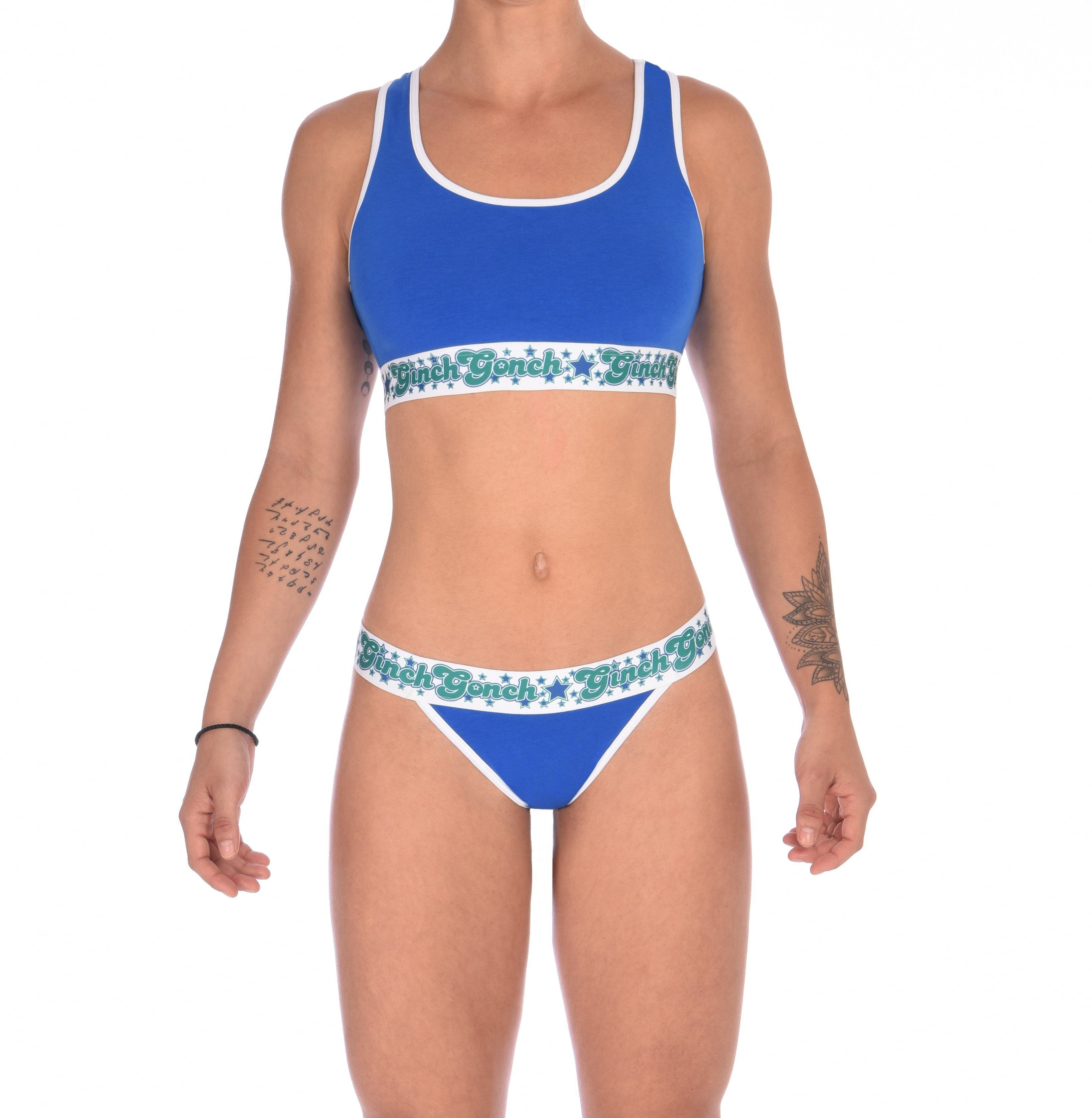 Full body view of a model of Ginch Gonch Blue Lagoon thong waistband construction and no-VPL stretch cotton in vibrant royal blue with matching sports bra
