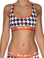 Ginch Gonch Backstage Pass Women's sports bra in bold diamond argyle print, 4-way stretch cotton racerback, worn by model