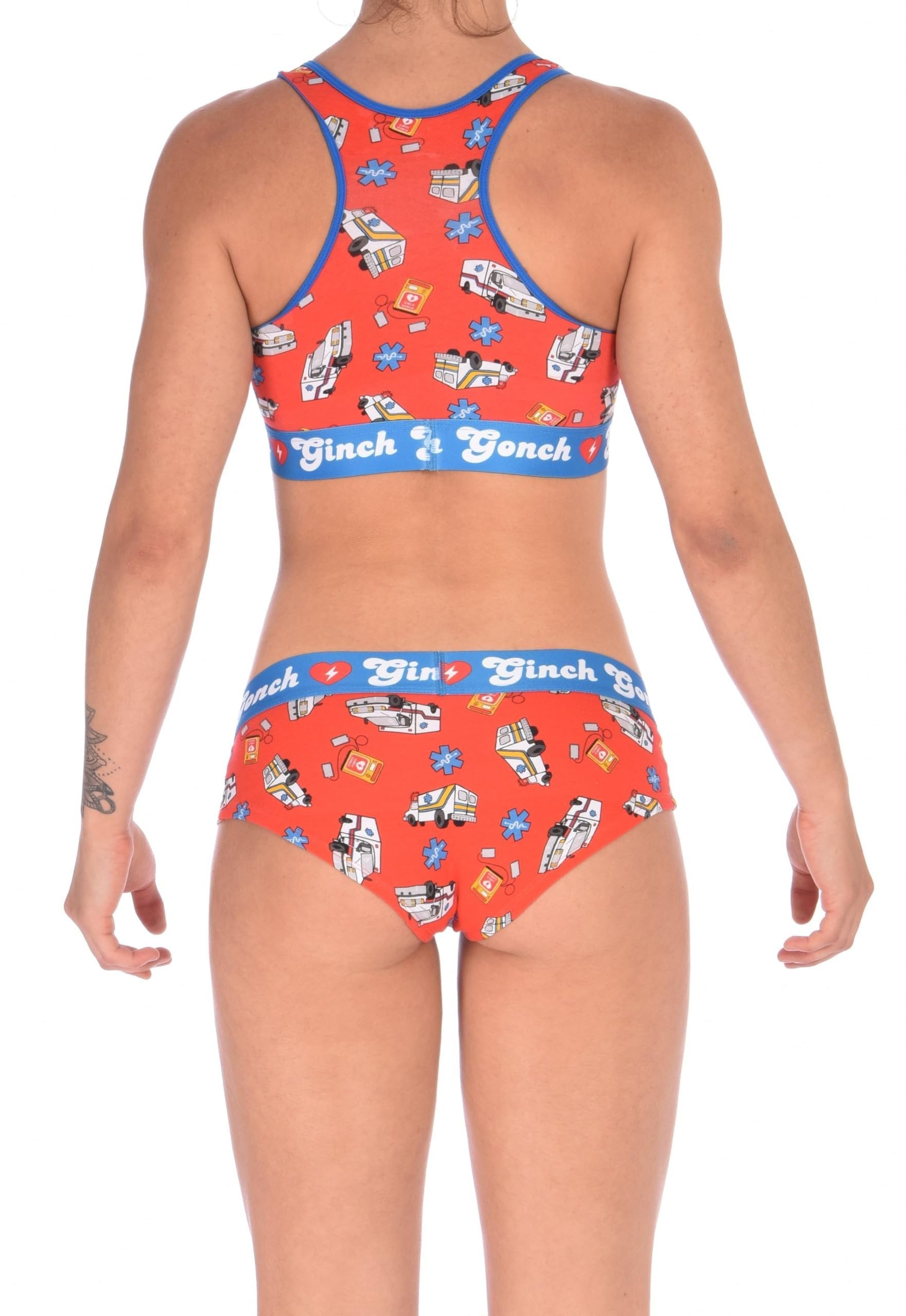 From the back, full body view of Ginch Gonch GG EMT gogo briefs showing anti-muffin waistband and medical print stretch cotton along with a sports bra.