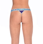 Rear view detail of Ginch Gonch Purple Haze thong showing minimal coverage and bold color block stretch cotton worn by a model.