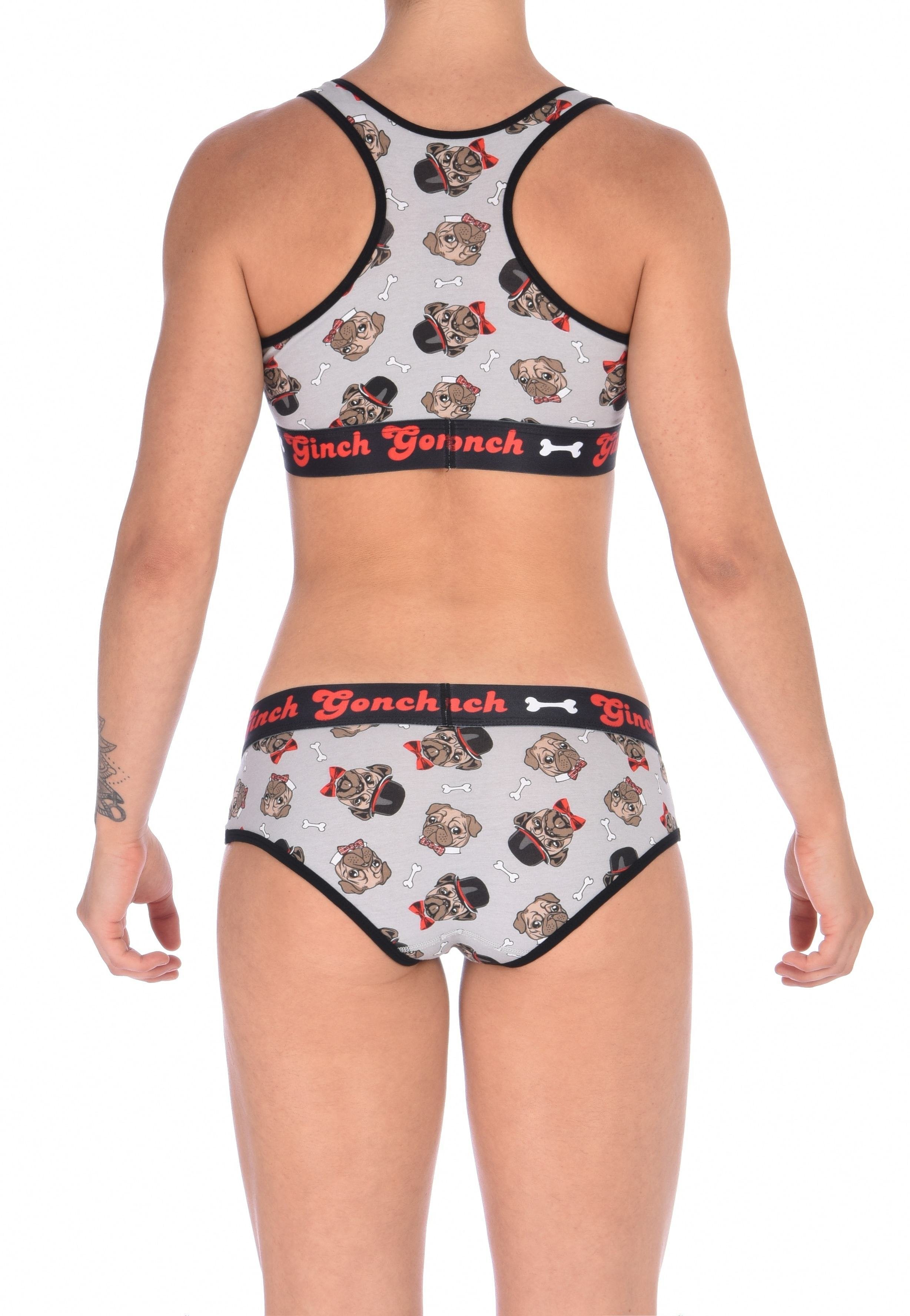 From the back view of a model wearing Ginch Gonch Pug Life boyfriend briefs showing full seat coverage and pug print stretch cotton fabric with matching sports bra.