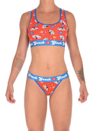 Full set view of a woman wearing Ginch Gonch GG EMT thong showing minimal coverage and medical print stretch cotton fabric.
