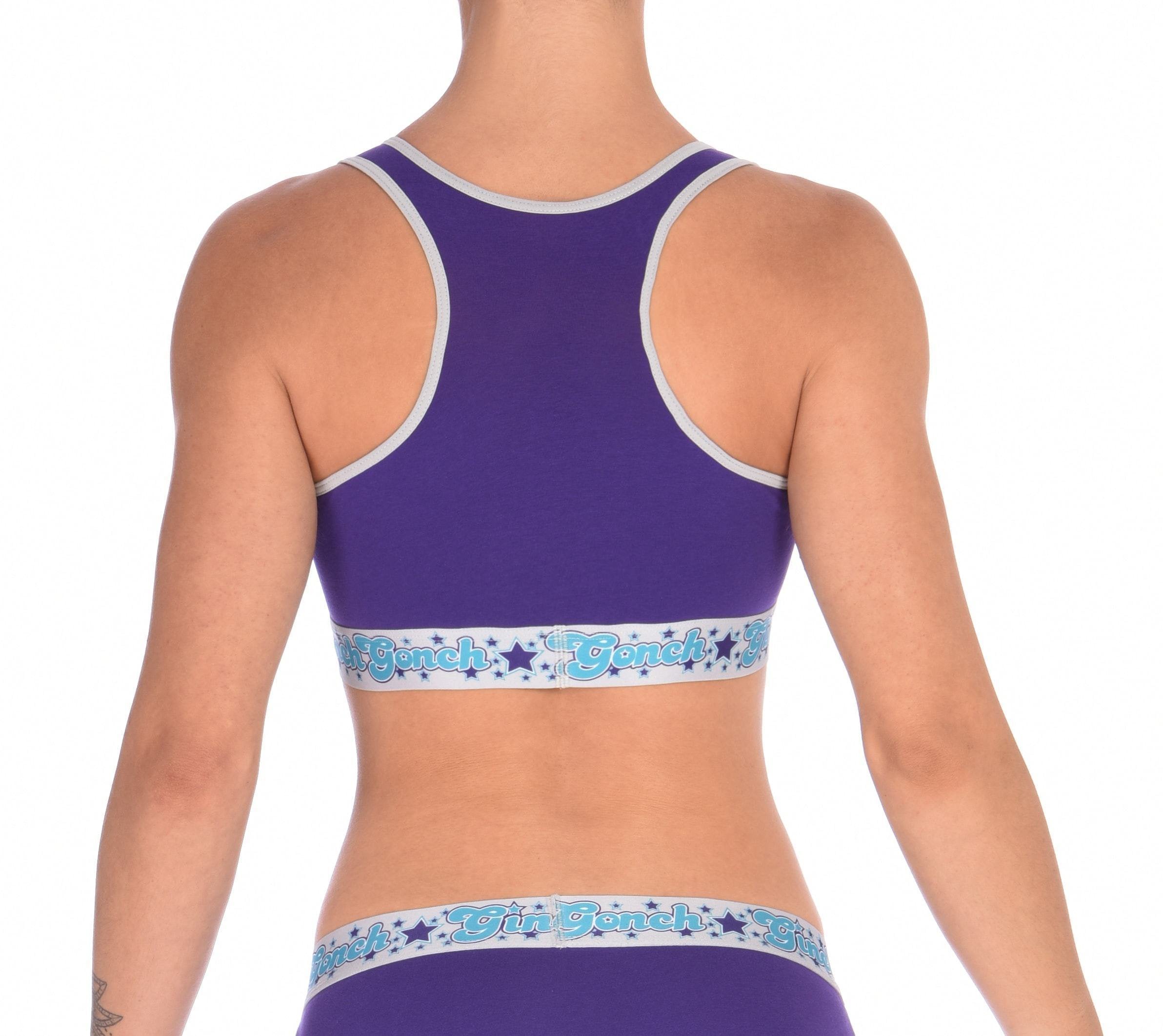 Rear view detail of Ginch Gonch Purple Haze sports bra showing racerback strap design and color block stretch cotton worn by a model.