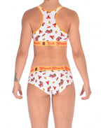 Rear view of a model waearing a  Ginch Gonch GG Fire Fighters gogo briefs showing anti-muffin waistband and firefighter print cotton and a same sports bra.
