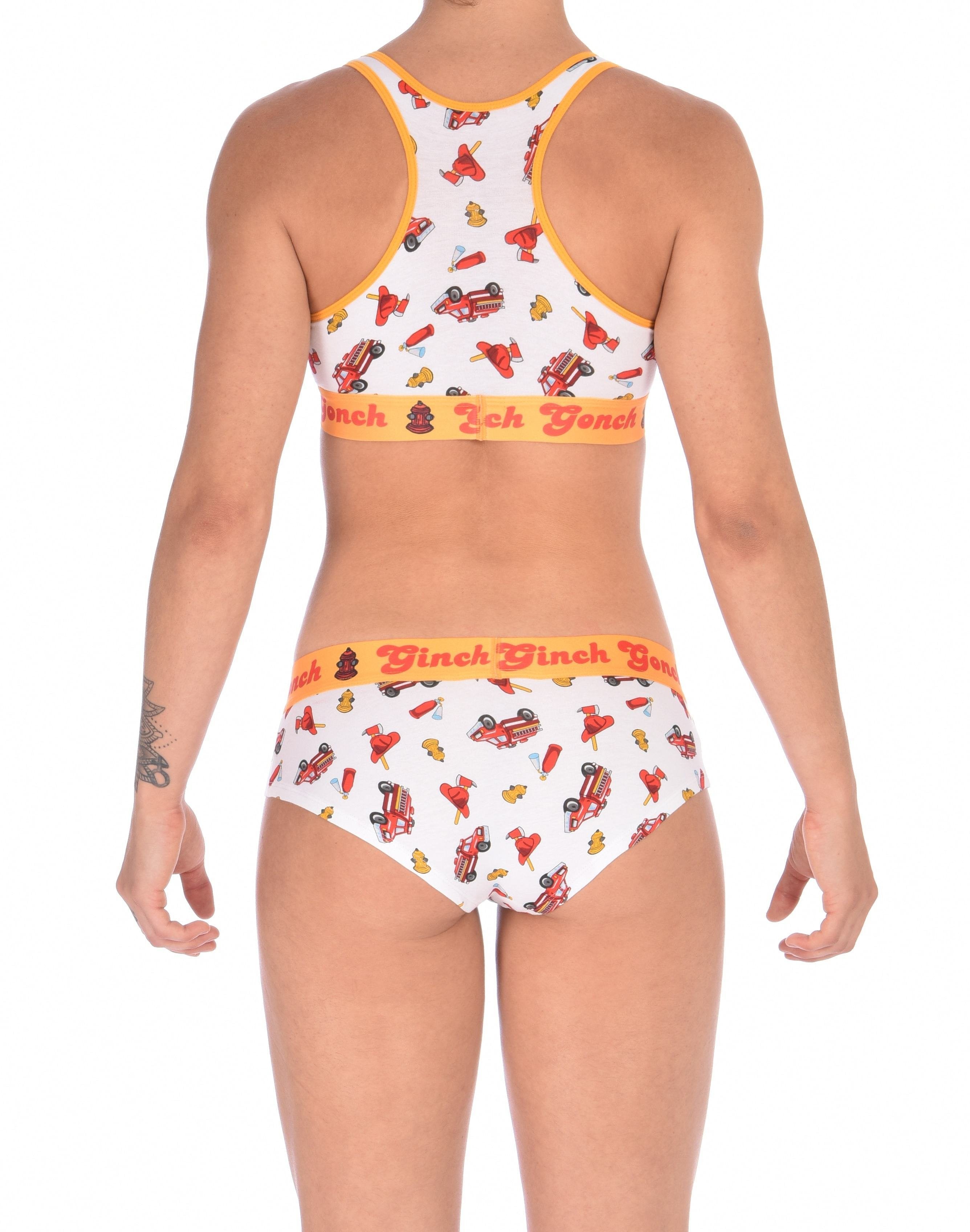Rear view of a model waearing a  Ginch Gonch GG Fire Fighters gogo briefs showing anti-muffin waistband and firefighter print cotton and a same sports bra.