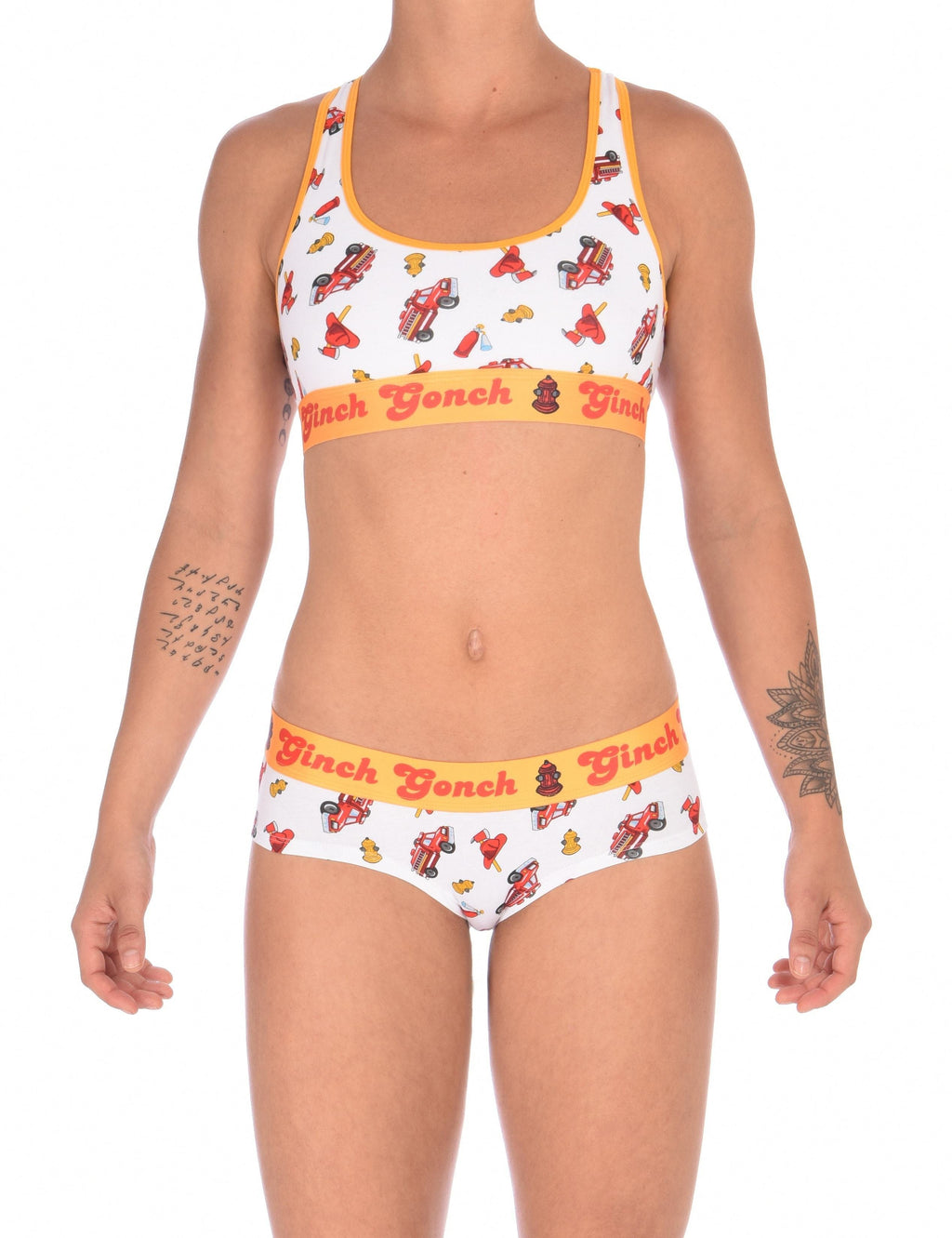 Full oufit view of a model wearingGinch Gonch GG Fire Fighters gogo briefs showing anti-muffin waistband and firefighter print cotton with amatching sports bra.