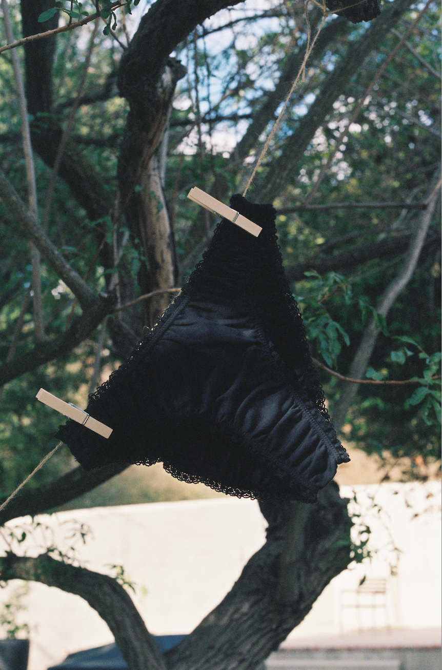 Paulette & Maria Black organic cotton panties, eco-friendly laundry lifestyle shot.