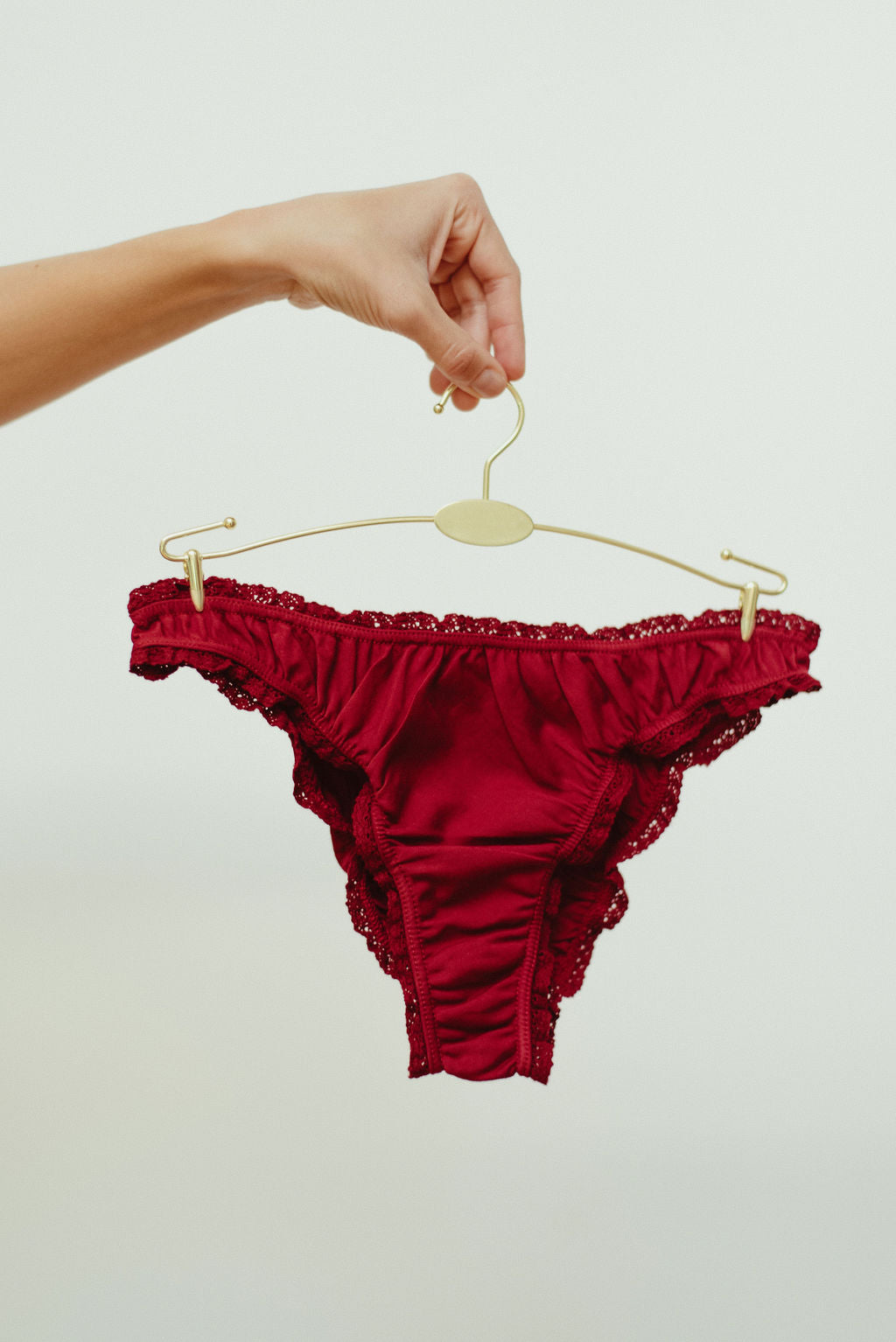 Paulette & Maria Burgundy organic cotton frilly panties, front view on a white background.