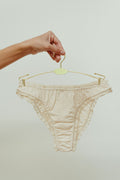 Paulette & Maria Natural dye-free organic cotton frilly panties, front view on a white background.
