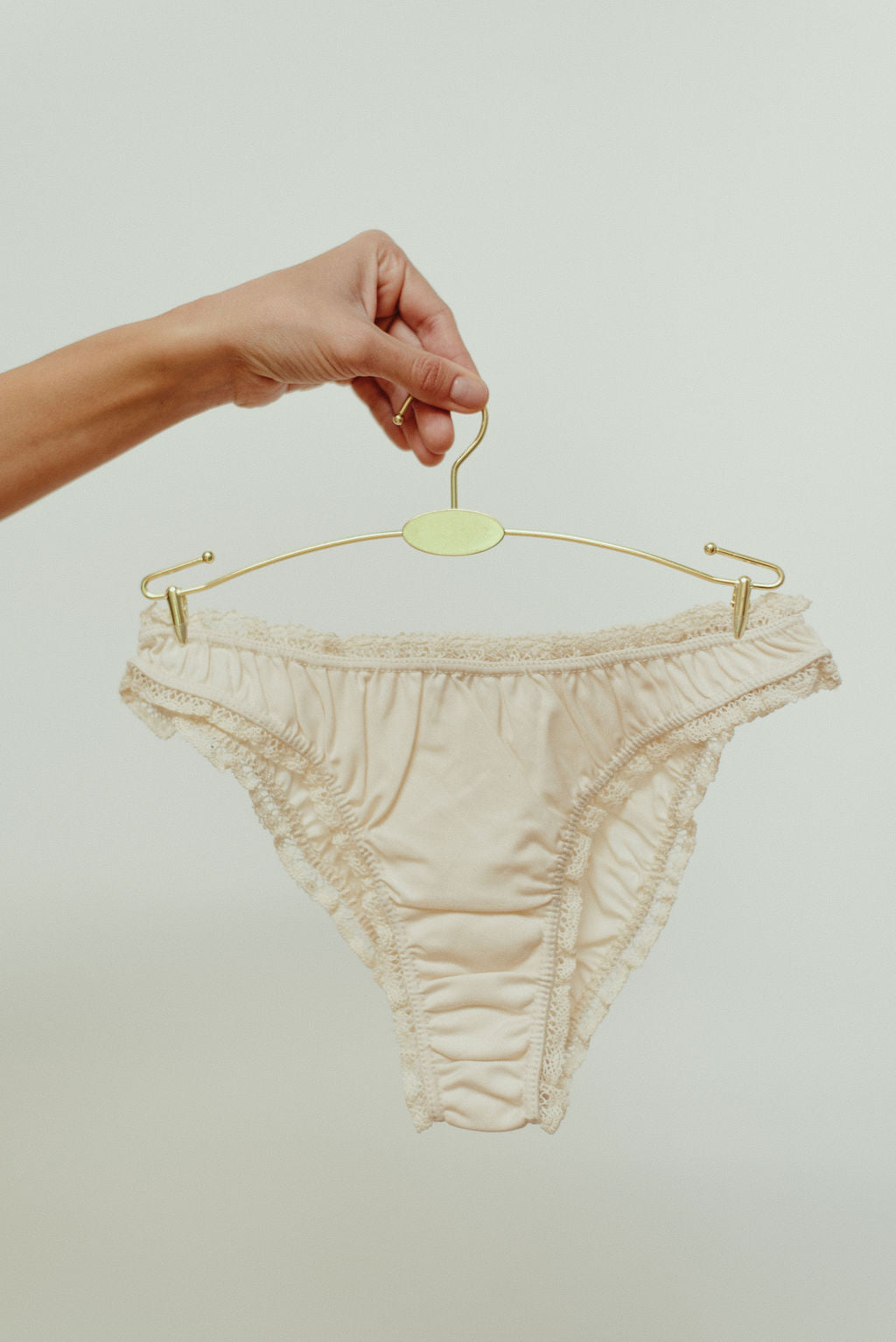 Paulette & Maria Natural dye-free organic cotton frilly panties, front view on a white background.