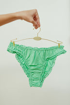 Paulette & Maria Neptune Green organic cotton frilly panties, front view on a white background.
