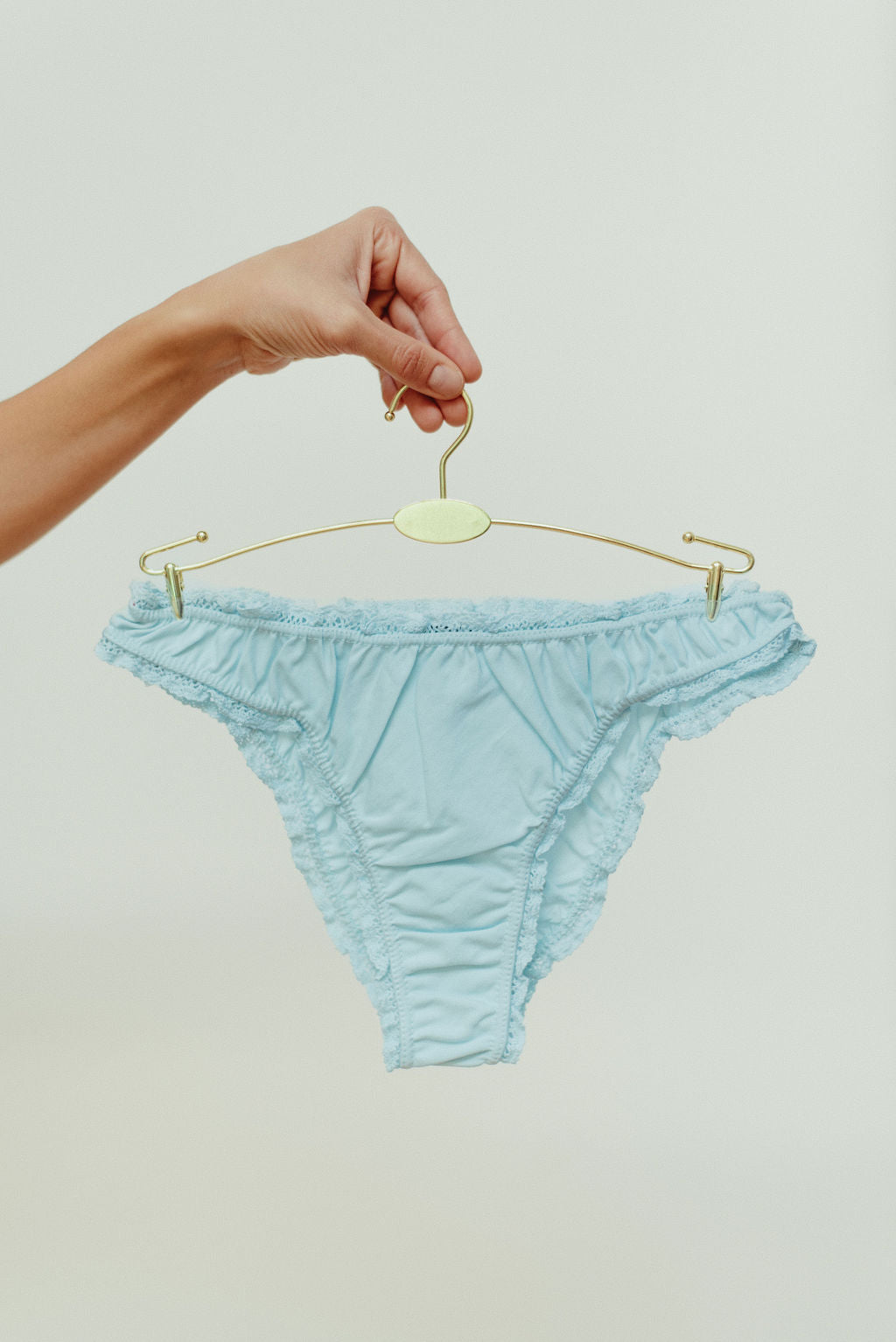 Paulette & Maria Pastel Blue organic cotton frilly panties, front view on a white background.