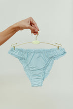 Paulette & Maria Pastel Blue organic cotton frilly panties, front view on a white background.