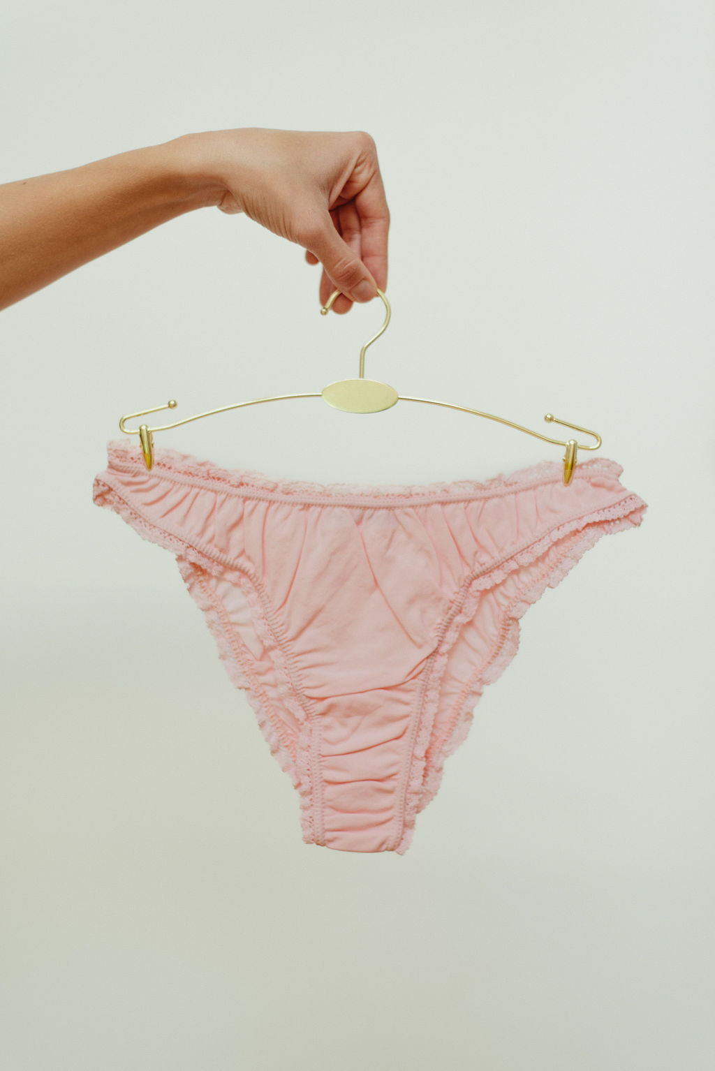 Paulette & Maria Powder Pink organic cotton frilly panties, front view on a white background.