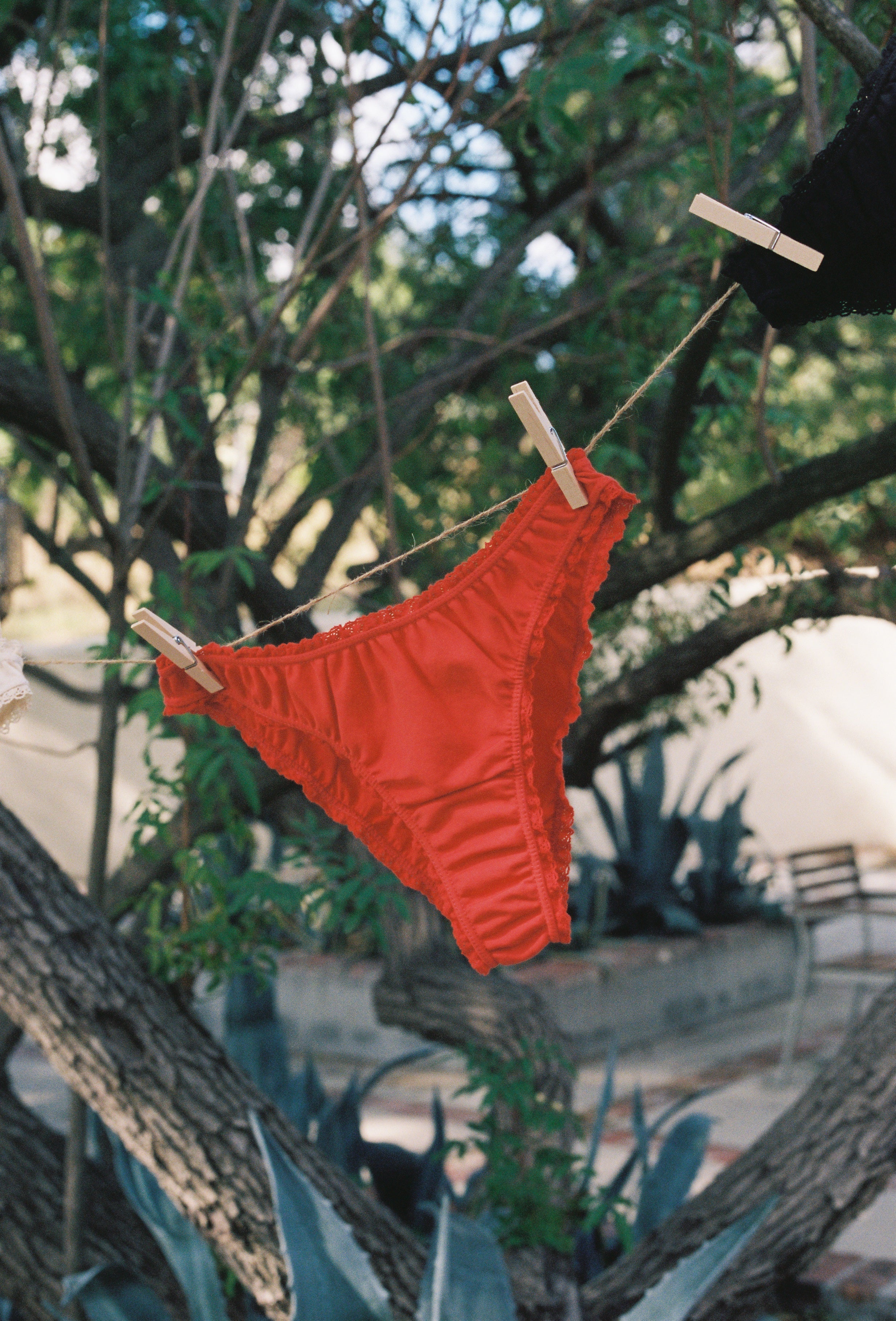 Paulette & Maria Red organic cotton panties, eco-friendly laundry lifestyle shot.