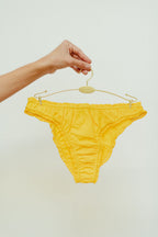 Paulette & Maria Yellow Lemon organic cotton frilly panties, front view on a white background.