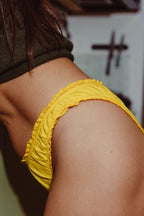 Paulette & Maria Yellow Lemon organic cotton panties, close-up ruffle detail on a white background.