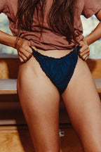 Paulette & Maria Sailor Blue frilly panties, model close-up front view on a white background.