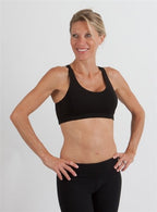 Spun Bamboo Women's Padded Sports Bra in Black, worn on model, side view on a white background.